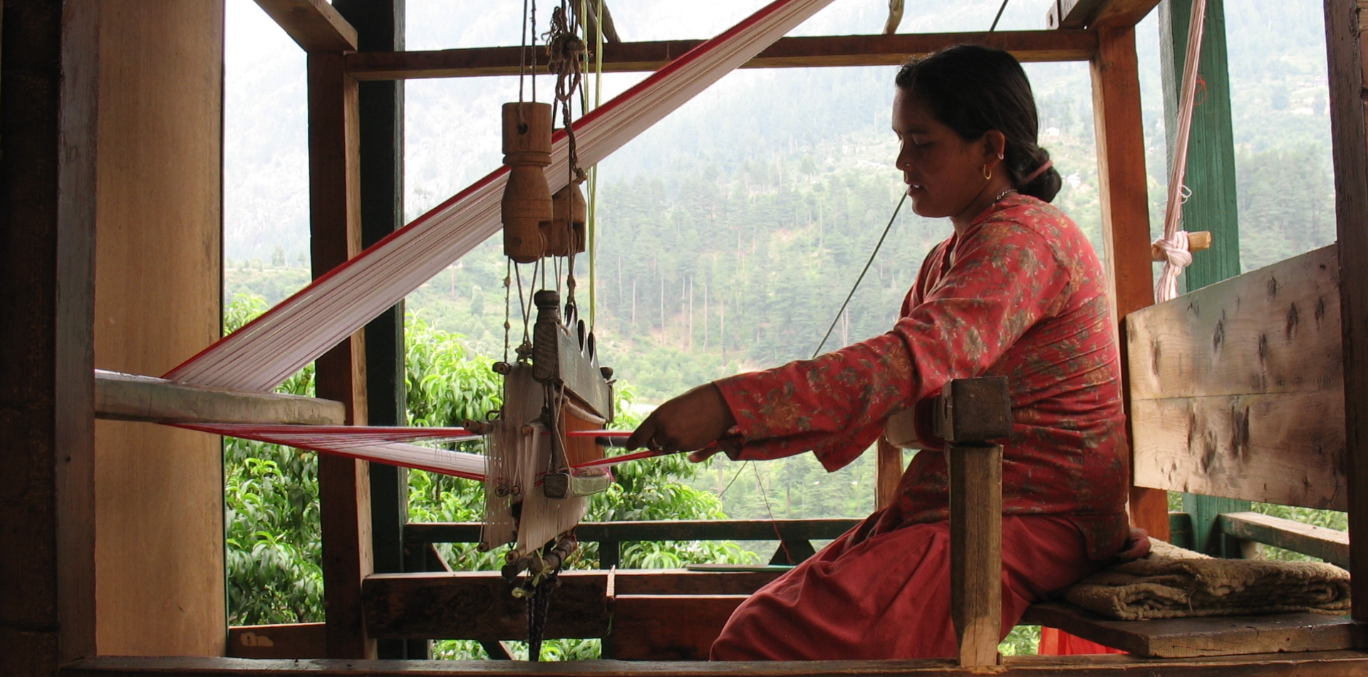 Female weaver working on a frame loom.