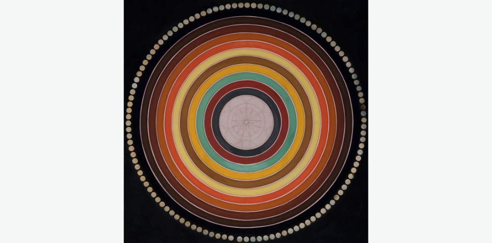 Set against a black background, a geometric and floral centre is surrounded by multi-coloured concentric rings with its outermost ring lined with white moons.