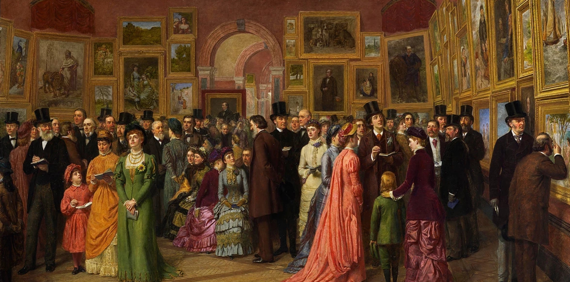 Men, women and children formally dressed in top hats, tuxedos and evening gowns engage in conversation in a cramped space with walls filled with paintings.